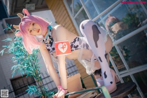 A woman in a cow costume posing for a picture.