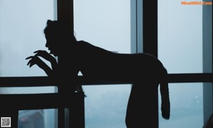 A woman sitting on a bed smoking a cigarette.