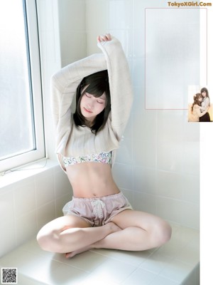 A woman in a school uniform is posing for a magazine.