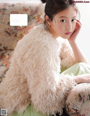 A magazine with a picture of a young girl on the cover.