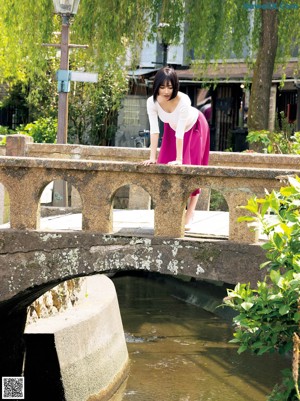 A woman with a towel wrapped around her breasts.