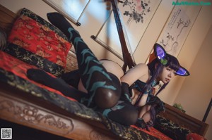 A woman in a black and blue outfit holding a sword.