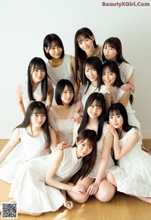 A group of girls in white dresses posing for a magazine.