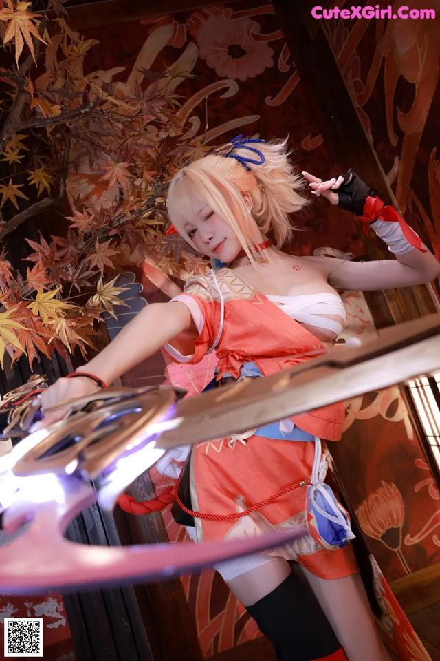 A woman in a kimono holding a sword in her hand.