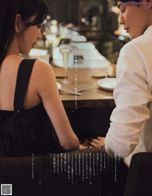 A man and a woman sitting at a table eating food.