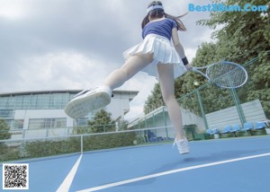 A woman in white stockings and a blue skirt is laying on the ground.