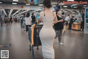 A woman wearing a face mask in a grocery store.