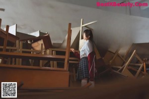 A woman sitting on top of a wooden chair.