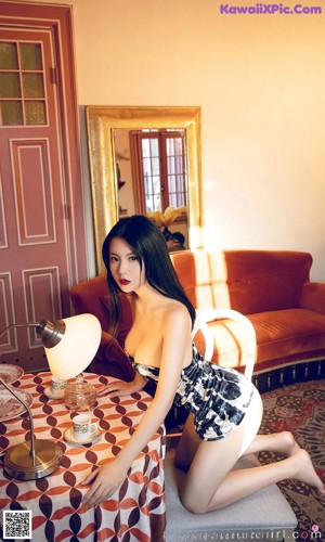 A woman sitting at a table in a room.