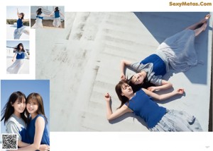 A couple of women standing on top of a sandy beach.