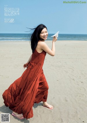 A woman in a white shirt and black skirt standing in a pool.